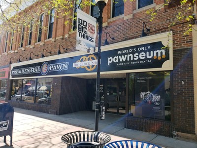 Store front for Presidential Pawn, The Clock Shop, and the World's Only Pawnseum
